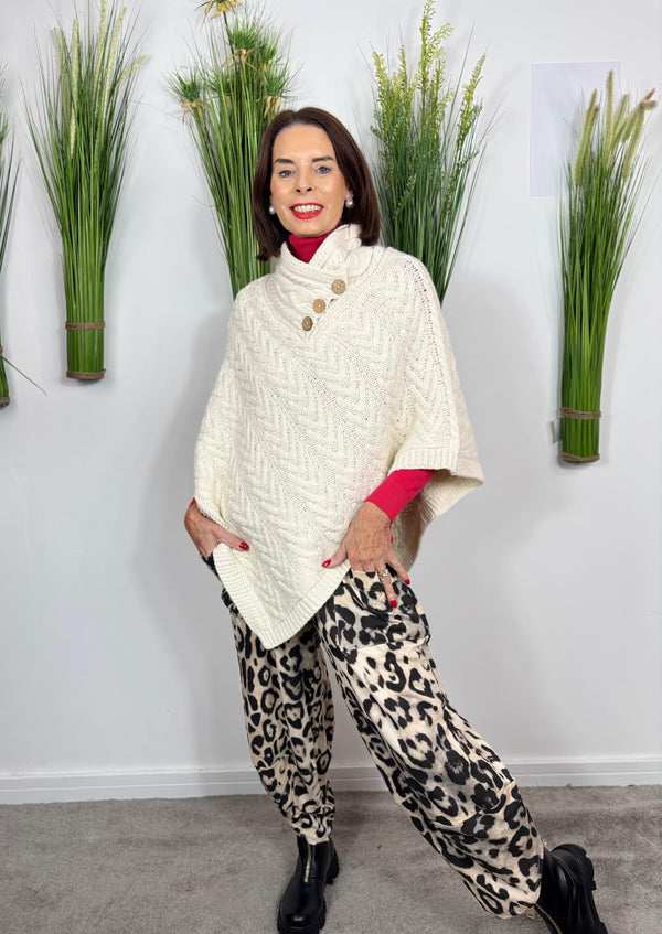 Cable knit poncho in cream
