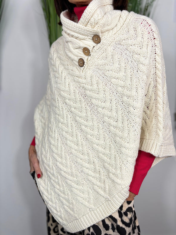 Cable knit poncho in cream