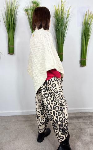 Cable knit poncho in cream