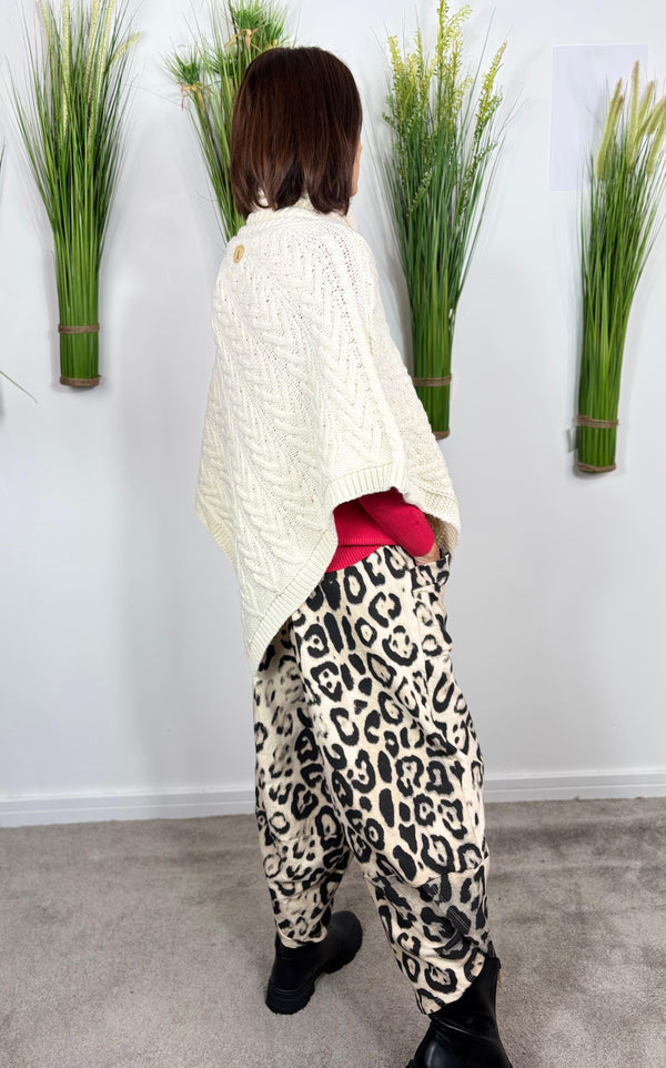 Cable knit poncho in cream
