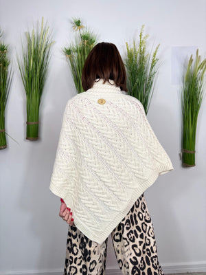 Cable knit poncho in cream