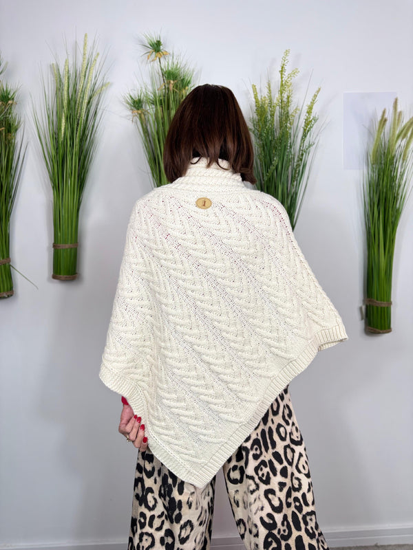 Cable knit poncho in cream