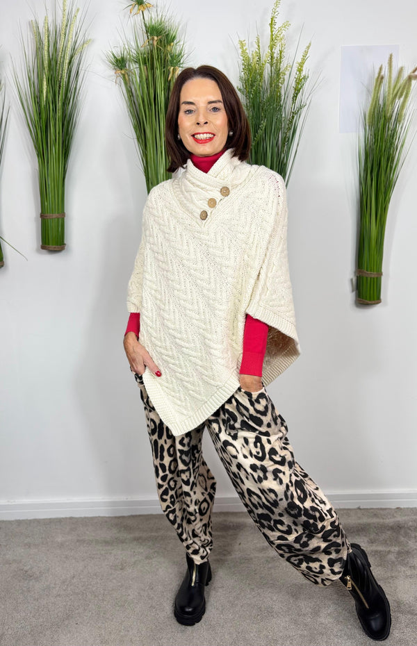 Cable knit poncho in cream